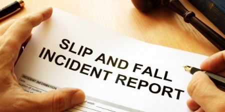 Person filling out slips and falls incident report form