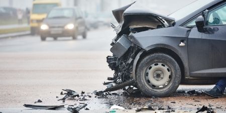 Image of a roadway and vehicle following a head-on automobile accident