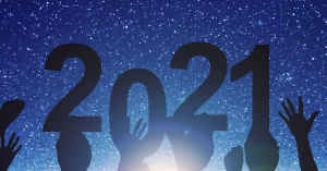 Several hands hold a "2021" sign against a starry sky